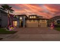 Two-story house with three-car garage, illuminated at night at 2518 Fontaine Dr, Kissimmee, FL 34741