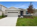 One-story home with two-car garage and landscaping at 154 Bull Frog Ln, Umatilla, FL 32784