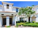 Front view of two-story townhome with landscaping at 8919 Stinger Dr, Davenport, FL 33896