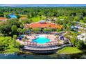 Community pool and clubhouse with surrounding landscape at 573 Viola Dr, Davenport, FL 33837