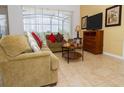 Comfortable living room with neutral colored furniture and tile floors at 573 Viola Dr, Davenport, FL 33837