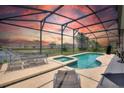 Relaxing screened-in pool and spa area with lounge chairs at 573 Viola Dr, Davenport, FL 33837