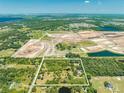 Aerial view of a secluded property with a pond and lush surroundings at 1235 Hackney Rd, St Cloud, FL 34771