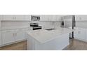 Modern kitchen with stainless steel appliances and an island at 4248 Sawtooth Ct, Tavares, FL 32778