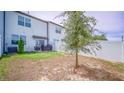 Backyard features a patio, grassy area, and a privacy fence, ideal for outdoor enjoyment at 350 Madison Dr, Davenport, FL 33837
