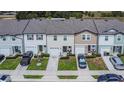 Aerial view of a row of townhomes, offering a perspective on the community layout and parking at 350 Madison Dr, Davenport, FL 33837