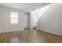 Living room with wood-look tile flooring and staircase at 1520 Erin Breeze Ln, Kissimmee, FL 34744