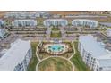 Community view showcasing apartment buildings, pool, and parking at 3191 Paradox Cir # 205, Kissimmee, FL 34746