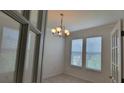 Bright dining room with chandelier and french doors at 2391 Beacon Park Landing Cir, Orlando, FL 32824