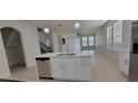 Open concept kitchen with island and stainless steel appliances at 2391 Beacon Park Landing Cir, Orlando, FL 32824