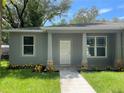 Front view of a gray house with a white door and stone accents at 1730 Old Apopka Rd, Apopka, FL 32703