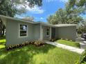 Gray house with stone accents, walkway, and well-maintained landscaping at 1730 Old Apopka Rd, Apopka, FL 32703
