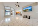 Spacious living room with tile floors and a view of the kitchen at 4446 Weeping Willow Cir, Casselberry, FL 32707