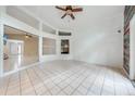 Bright sunroom with tiled floors and a rustic wood accent wall at 4446 Weeping Willow Cir, Casselberry, FL 32707