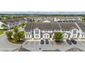 Aerial of townhome community with parking and pond at 301 Captiva Dr, Davenport, FL 33896