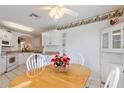White kitchen with wood dining table and built in hutch at 114 Ridge View Dr, Davenport, FL 33837