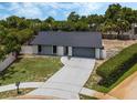 Single-story home with gray roof and driveway, aerial view at 986 Coply Ct, Casselberry, FL 32707