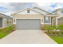One-story house with gray garage door and landscaping at 6349 Clover St, Lake Hamilton, FL 33851