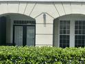Exterior view of condo building with double doors and lush landscaping at 239 Longview Ave # 107, Celebration, FL 34747