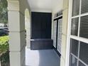 Private condo patio with black storage bench and access to double doors at 239 Longview Ave # 107, Celebration, FL 34747