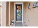 Front door with glass panels, fall wreath, and decor at 694 Irvine Ranch Rd, Kissimmee, FL 34759