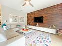Light and airy living room with a comfortable sectional sofa and stylish decor at 2955 Beach Palm Ave, Kissimmee, FL 34747