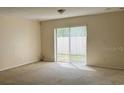 Bright living room with sliding glass doors leading to a patio at 624 Cresting Oak Cir # 32, Orlando, FL 32824
