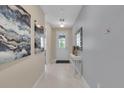 Bright and airy entryway with tile flooring and modern wall art at 1770 Sawyer Palm Pl, Kissimmee, FL 34747