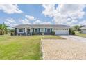 Ranch style home with landscaped yard at 720 Shore Drive, Kissimmee, FL 34744
