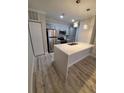 Modern kitchen with island and stainless steel appliances at 714 Siena Palm Dr # 203, Celebration, FL 34747