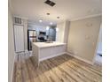 Modern kitchen with island and stainless steel appliances at 714 Siena Palm Dr # 203, Celebration, FL 34747