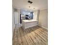 Modern kitchen with island and stainless steel appliances at 714 Siena Palm Dr # 203, Celebration, FL 34747