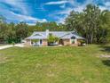 House with large grassy yard, trees and driveway at 4450 Kaiser Ave, St Cloud, FL 34772