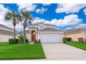 Two-story house with a brown door and palm trees at 8612 La Isla Dr, Kissimmee, FL 34747