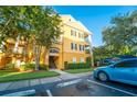 Attractive yellow building exterior with balconies and landscaping at 3593 Conroy Rd # 437, Orlando, FL 32839