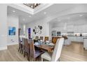 Large dining room with a spacious table and modern kitchen at 494 Muirfield Loop, Reunion, FL 34747