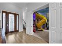 Bright entryway with glass double doors and a unique indoor slide feature at 494 Muirfield Loop, Reunion, FL 34747