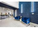 Bright entryway with blue velvet chairs and geometric wallpaper at 1125 Grand Traverse Pkwy, Reunion, FL 34747