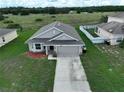 Single-story home with a two-car garage and driveway at 2513 Rock Pl, Kissimmee, FL 34759