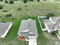 Single-story house, large backyard, and neighborhood view at 2513 Rock Pl, Kissimmee, FL 34759