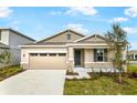 One-story home with stone accents and garage at 176 Flag Lilly Ln, Umatilla, FL 32784