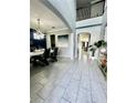 Bright and spacious entryway with tile flooring, high ceilings, and views to the living room at 12351 Northover Loop, Orlando, FL 32824