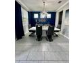 Elegant dining room with a large table, modern chairs, and a stylish chandelier at 12351 Northover Loop, Orlando, FL 32824