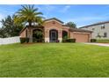 One-story house with a two-car garage and palm trees at 840 Crooked Branch Dr, Clermont, FL 34711