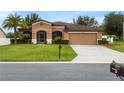 One-story house with a two-car garage and palm trees at 840 Crooked Branch Dr, Clermont, FL 34711