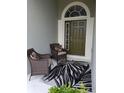Inviting entryway with two wicker chairs and decorative rug at 3601 Daydream Pl, Saint Cloud, FL 34772