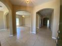 Spacious foyer with tile floors and arched hallways at 3601 Daydream Pl, Saint Cloud, FL 34772