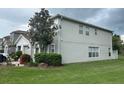 Gray two-story house with landscaping and a large tree at 2480 Hassonite St, Kissimmee, FL 34744