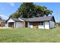 Contemporary home exterior with landscaped lawn at 7808 Clubhouse Estates Dr, Orlando, FL 32819