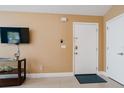 Bright and airy entryway with a flat-screen TV and neutral color scheme at 5012 Laguna Bay Cir # 74, Kissimmee, FL 34746